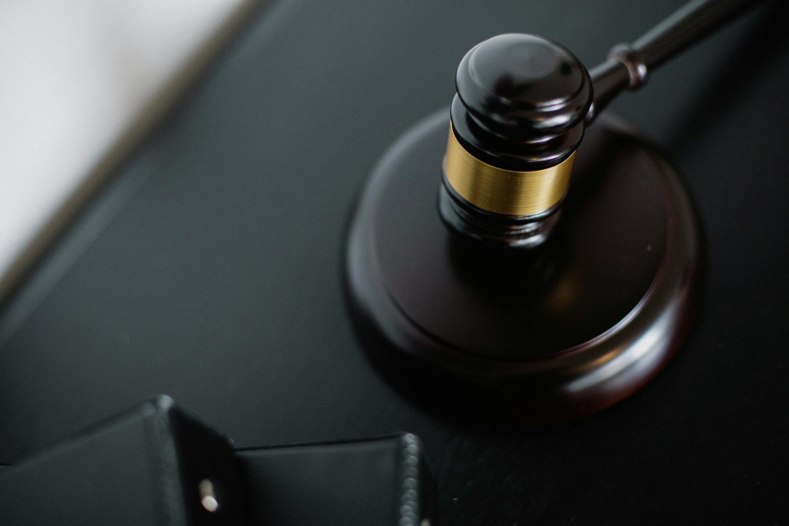 service-1 From above of wooden gavel on round surface near folders on table in courtroom